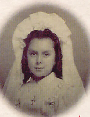 Oval portrait of a little girl with dark hair, wearing a white First Communion veil